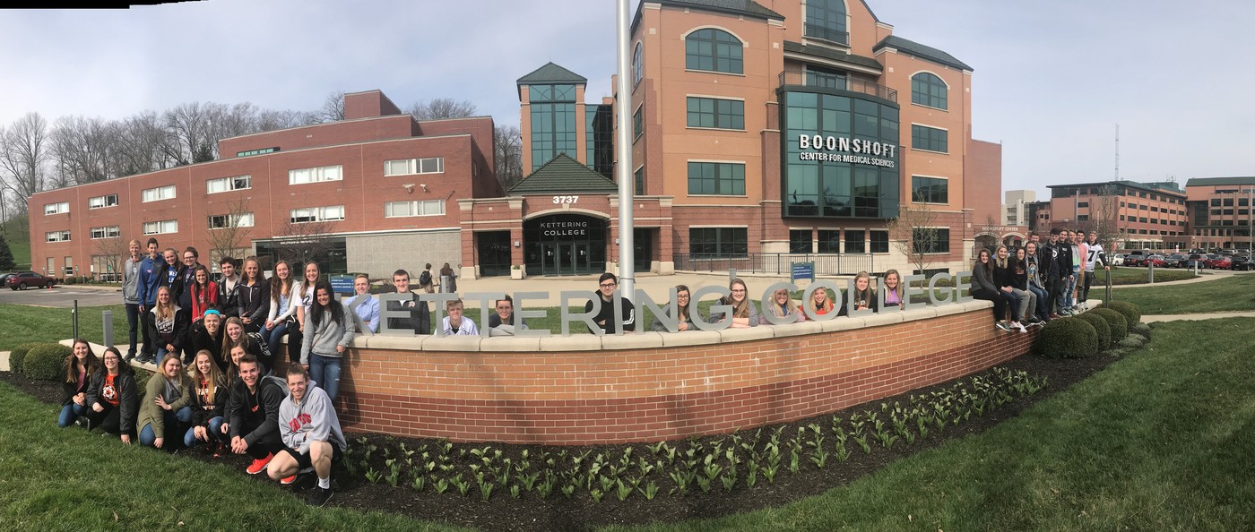 a group of students posing in front of a hospital